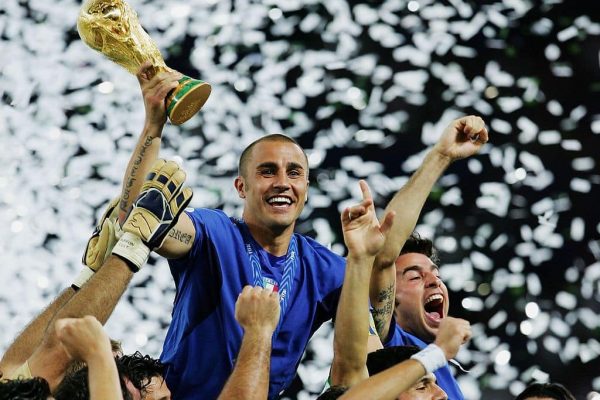 BERLIN - JULY 09:  The Italian players celebrate as Fabio Cannavaro of Italy lifts the World Cup trophy aloft following victory in a penalty shootout at the end of the FIFA World Cup Germany 2006 Final match between Italy and France at the Olympic Stadium on July 9, 2006 in Berlin, Germany.  (Photo by Alex Livesey/Getty Images)