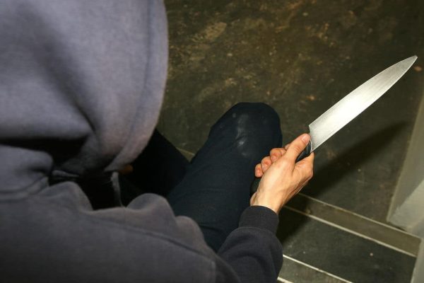 PICTURE POSED BY MODEL. A general view of a man in a hoodie holding a knife.   (Photo by Katie Collins - PA Images/PA Images via Getty Images)